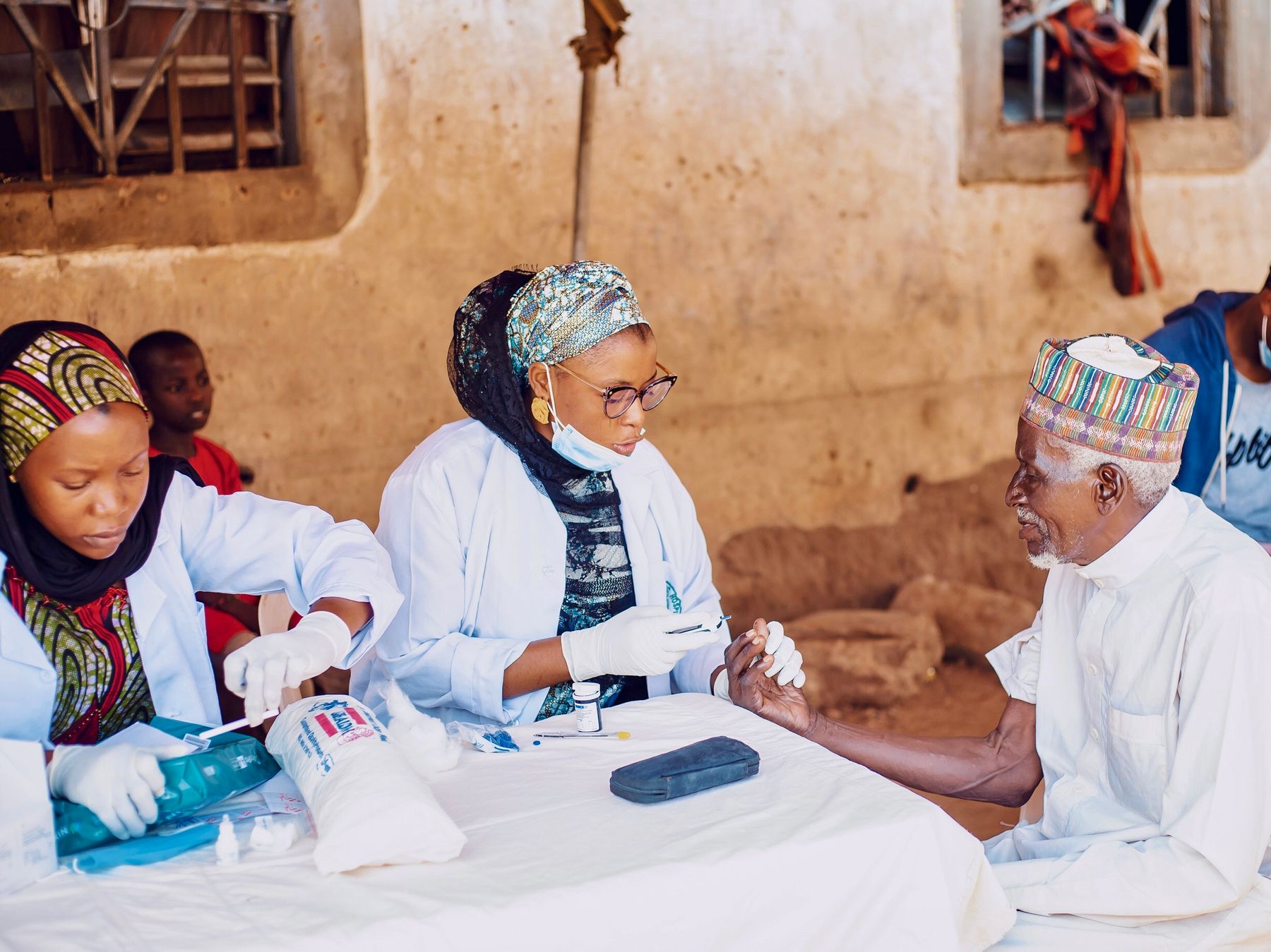 A healthcare worker supporting a community member during an outreach activity